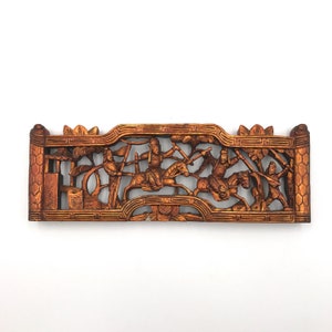 May include: A carved wooden panel with a gold finish depicting a scene of warriors on horseback. The panel is intricately detailed with figures, trees, and a pagoda.