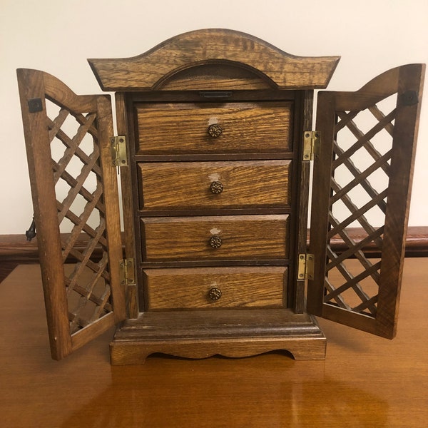 Wooden Musical Jewelry Box with 4 drawers.  Lovely gold velvet lining in the drawers and ring holders included in drawer.