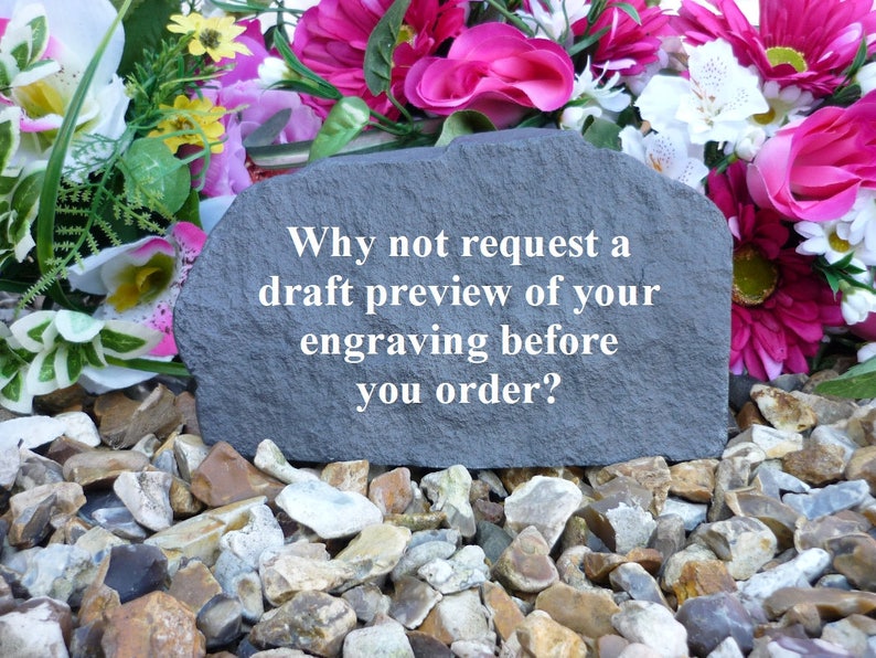 May include: A gray stone with the text "Why not request a draft preview of your engraving before you order?" on it. The stone is surrounded by small, gray, brown, and white rocks.