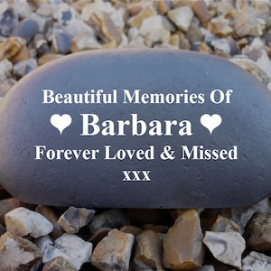 May include: A grey stone with the text "Beautiful Memories Of Barbara Forever Loved & Missed XXX" in white lettering.