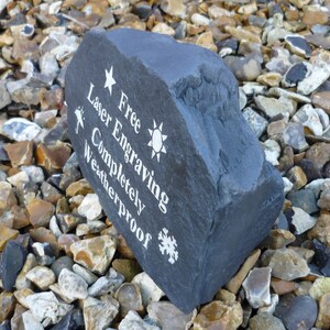 May include: A dark gray stone with white text that reads "Free Engraving Laser Etched Completely Weatherproof" with a star, sun, and snowflake symbols.