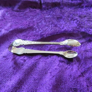 Vintage silver plated sugar tongs.