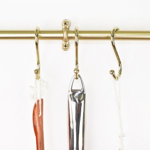 Hanging Brass Kitchen Hooks on a Kitchen Rail with Hooks