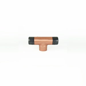 May include: Copper T-shaped pipe fitting with black end caps.