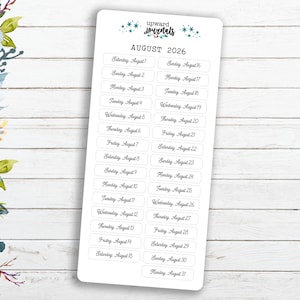 May include: A sheet of white stickers with the days of the week and dates for August 2026. The stickers are designed for use in a planner or journal.