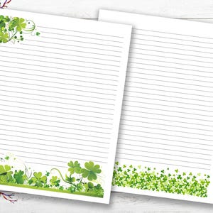 May include: Two lined stationery sheets with a St. Patrick's Day theme. One sheet has a green shamrock border and corner design. The other sheet has a green shamrock border. The sheets are white with gray lines.
