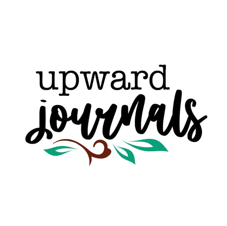 May include: Black and white calligraphy text that reads "upward journals" with a brown and green floral design underneath.
