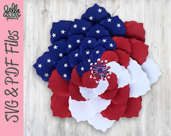 May include: A red, white, and blue paper flower with a star-spangled center. The flower is made of multiple layers of paper, creating a 3D effect. The flower is perfect for patriotic decorations.