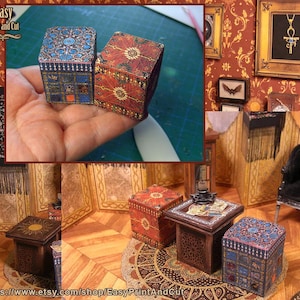 May include: Miniature decorative boxes with intricate patterns in blue, red, and gold. The boxes are displayed in a dollhouse setting, alongside small tables and rugs. The scene evokes a vintage or antique aesthetic.