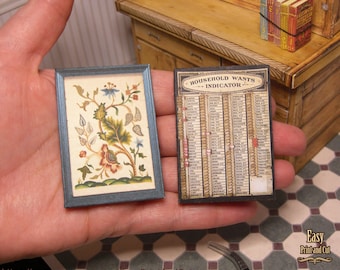 May include: Two miniature framed prints. The first print is a floral design with a blue, green, and red color scheme. The second print is a black and white list titled "Household Wants Indicator".