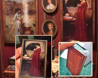 May include: A collection of miniature framed art prints featuring classical paintings, including a woman in a red dress holding a crystal ball and a figure by a cauldron. The set includes rectangular and oval frames with ornate gold-toned borders.