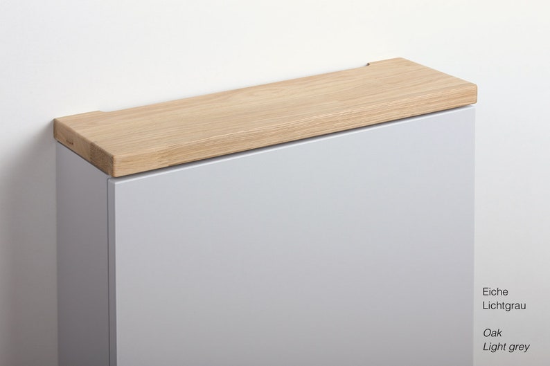 May include: A light grey cabinet with a wooden oak top. The cabinet is made of wood and has a modern design.
