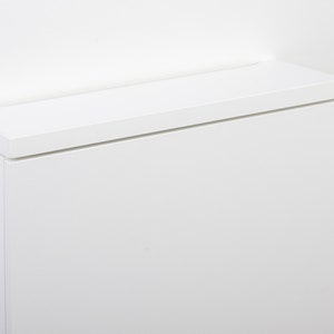 May include: White cabinet with a flat top and a white background.
