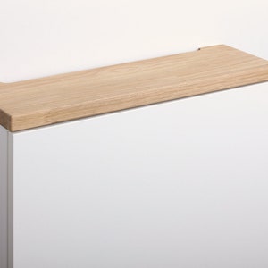 May include: A white cabinet with a light wood top. The cabinet is labelled "Eiche Wei&szlig;" and "Oak White".