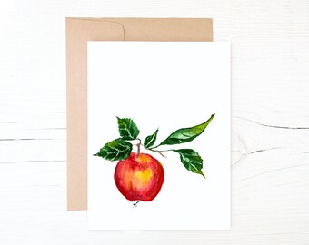 May include: A watercolor painting of a red apple with green leaves on a white background.