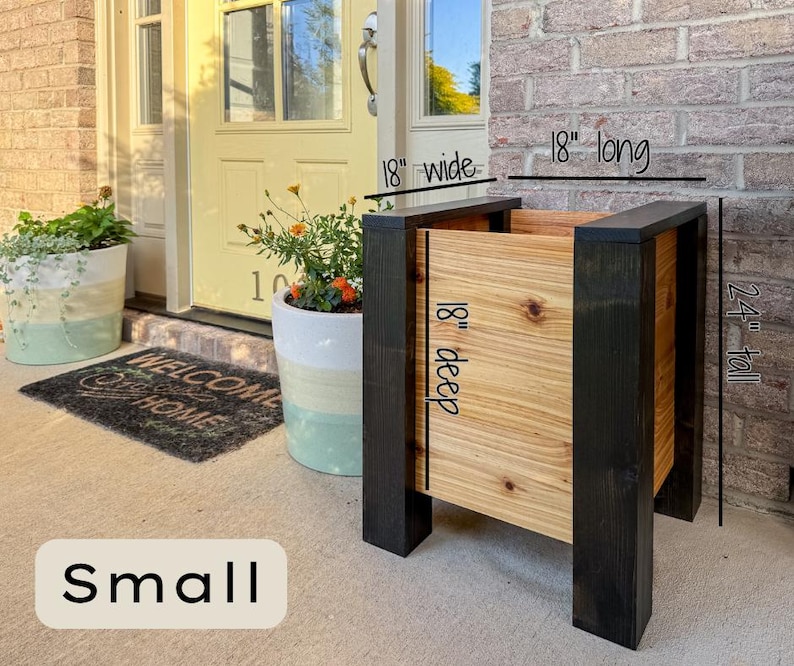 May include: A small wooden planter box with black trim and natural wood panels. The planter is 18 inches wide, 18 inches deep, 18 inches long, and 24 inches tall. The word "Small" is at the bottom.