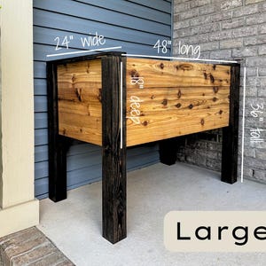 May include: Large wooden planter box, 24 inches wide, 48 inches long, 18 inches deep, and 36 inches tall. The planter has a natural wood finish with black legs and trim. The word "Large" is displayed at the bottom.