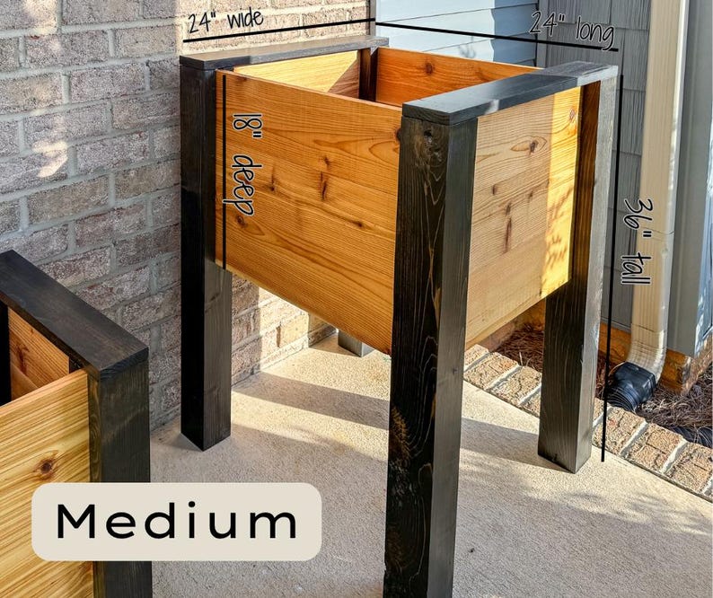 May include: A medium-sized wooden planter box with a natural wood finish and dark stained legs. The planter is 24 inches wide, 24 inches long, 18 inches deep, and 36 inches tall. The word "Medium" is displayed at the bottom.