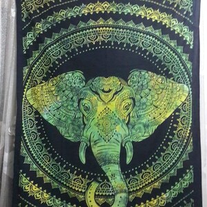 May include: Green and yellow mandala tapestry with an elephant design. The elephant is in the center of the mandala and has intricate details.