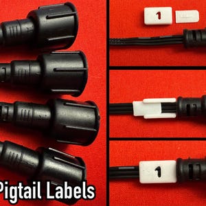 May include: Four black flatwire pigtail connectors with white labels numbered 1 through 4. The labels are attached to the wires. The connectors are on a red surface.