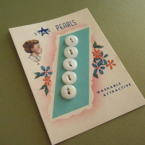 May include: A vintage-style card labeled STAR PEARLS featuring five round white buttons arranged in a vertical column. The card displays a graphic of a person in profile, blue and orange floral illustrations, and the text WASHABLE ATTRACTIVE.