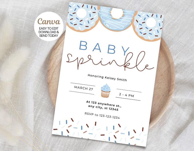 Może przedstawiać: Zaproszenie na baby shower z motywem niebieskich i brązowych posypek. Zaproszenie przedstawia pączka z niebieskim lukrem i brązowymi posypkami, babeczkę z niebieskim lukrem i posypką na wierzchu oraz tekst "Baby Sprinkle" w brązowym, ozdobnym piśmie. Zaproszenie zawiera r&oacute;wnież datę, godzinę i miejsce wydarzenia.