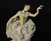 Broken Ballerina Aelteste Volkstedter porcelain ballerina with lace skirt and yellow bodice.
