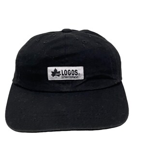 May include: Black baseball cap with a white patch that says "LOGOS OUTING EQUIPMENT" and a small maple leaf logo.