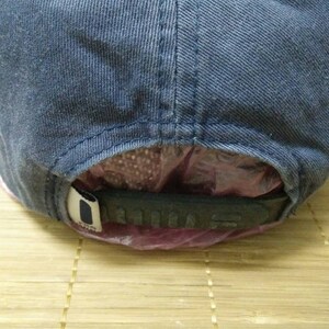 May include: A blue denim baseball cap with a black adjustable strap. The strap has the word "ADIDAS" printed on it.