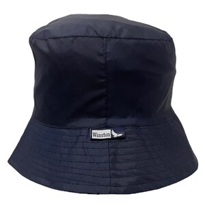 May include: A navy blue bucket hat with a small white logo that says "Winston" with a bird design.