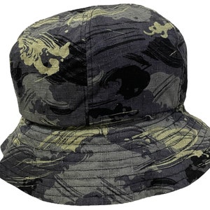 May include: A black and green bucket hat with a wave pattern.