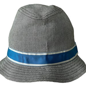 May include: A black and white patterned bucket hat with a blue and white ribbon around the crown.