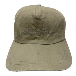 May include: A beige baseball cap with the text "MR. VAN 1956 Contemporarily American Life Style" embroidered on the front.