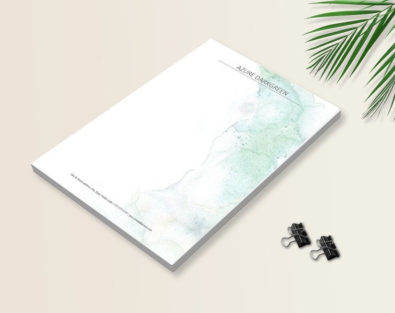 May include: A white notepad with a blue and green watercolor design. The notepad has the text "AZURE DARKGREEN" at the top.