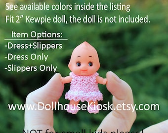 May include: A pink crocheted dress and matching slippers for a 2 inch Kewpie doll. The doll is not included.  The dress has a white trim and the slippers are white.  The text "www.DollhouseKiosk.etsy.com" is visible in the image.  The text "NOT for small kids please!" is also visible in the image.