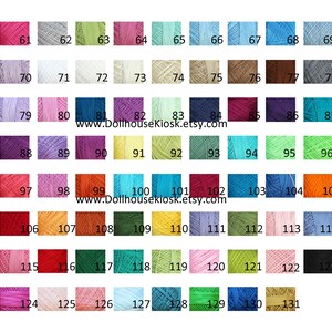 May include: A color chart of 131 different shades of embroidery floss. The floss is wound on small spools and arranged in rows. The colors range from bright to muted and include shades of red, orange, yellow, green, blue, purple, pink, brown, and gray.