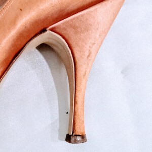 Slight mark on the outer side of the heel on the left shoe.