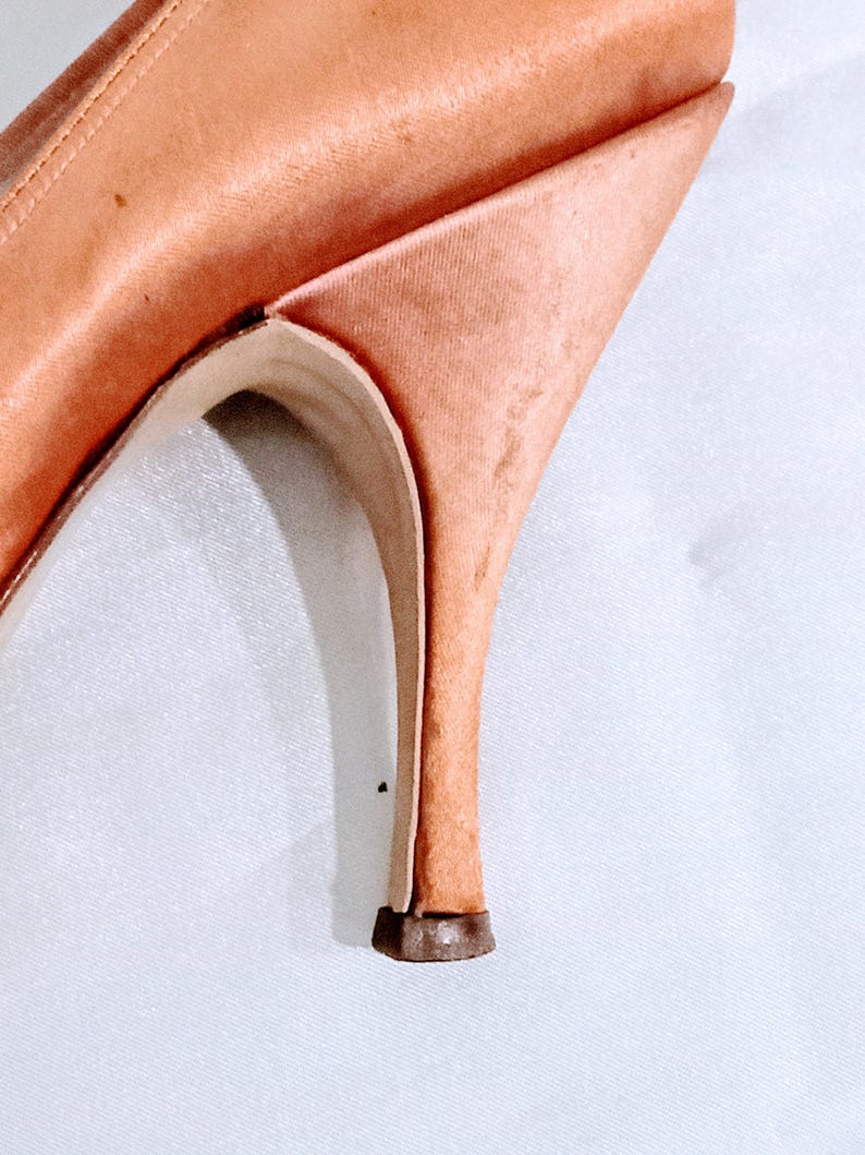 Slight mark on the outer side of the heel on the left shoe.
