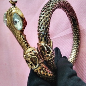 Vintage coiled Snake bracelet, with clear rhinestone eyes.