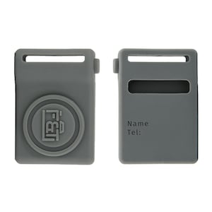 May include: Two gray silicone luggage tags. One tag features a circular emblem with the letters "FBT" inside. The other tag has a rectangular window and the words "Name" and "Tel:" printed on it.