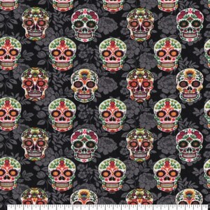 May include: A fabric with a repeating pattern of colorful sugar skull designs. The skulls are decorated with floral and geometric patterns in shades of red, orange, green, and yellow. The background is a dark gray floral print.