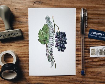 May include: A watercolor painting of a human spine with a grapevine growing from it. The vine has a green leaf and a bunch of purple grapes. The painting is on a white card with a wooden background.