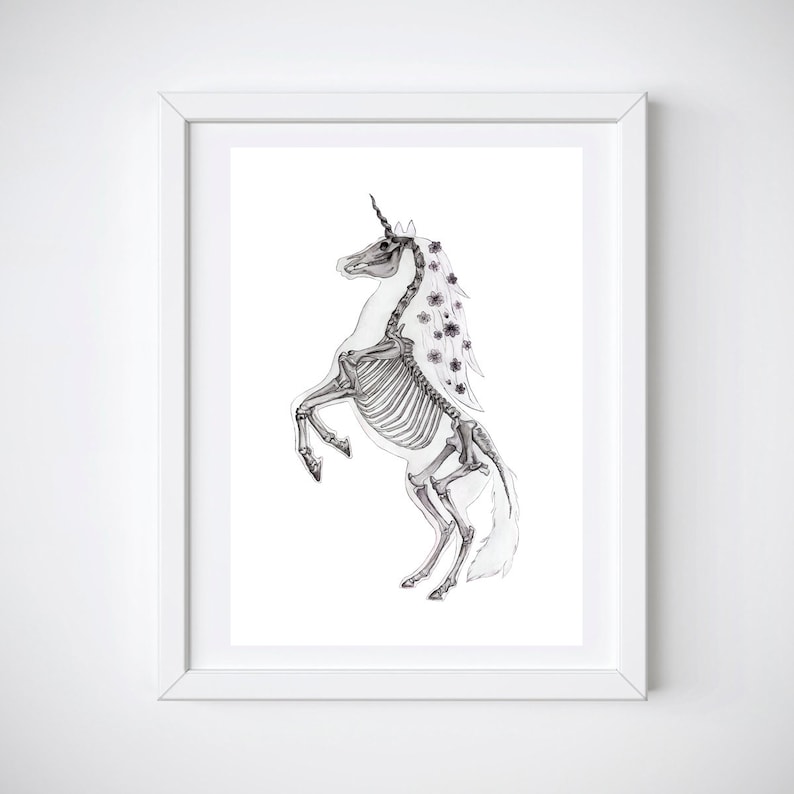 May include: A black and white illustration of a unicorn skeleton with a floral garland around its neck and mane. The unicorn is standing on its hind legs with its front legs raised.