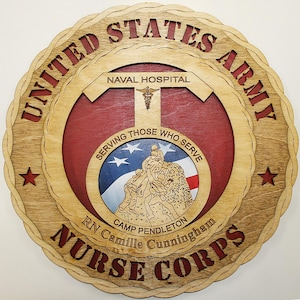 May include: Wooden plaque with the words "United States Army Nurse Corps" and "Naval Hospital." The plaque features a central design with a medical symbol and the text "Serving Those Who Serve." Includes a red, white, and blue design with the text "Camp Pendleton RN Camille Cunningham."