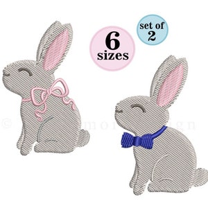 May include: Embroidered design set of two gray bunnies, one with a pink bow and the other with a blue bow. The design comes in six sizes.