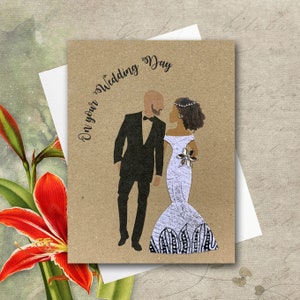 Wedding card showing bald white man with a brown beard and black woman with light brown skin and curly brown hair. Fabric dress is hourglass shape. Card colour is brown