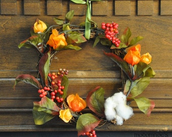 Festive Fall Wreath Featuring Orange Chinese Lanterns, Red Berries, Greenery, and Cotton