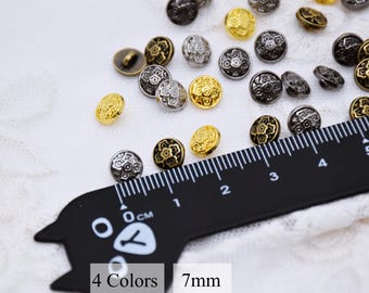 May include: Assortment of 7mm metal buttons with a decorative floral design. The buttons are available in four colors: gold, silver, bronze, and black.  4 Colors 7mm