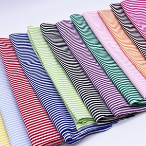 May include: A collection of ten striped fabric swatches in various colors, including yellow, blue, red, green, purple, pink, orange, and black.