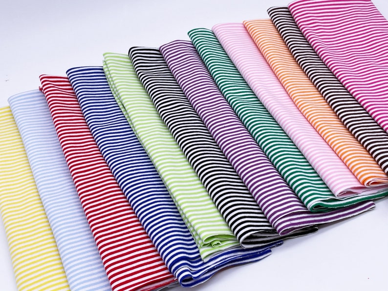 May include: A collection of ten striped fabric swatches in various colors, including yellow, blue, red, green, purple, pink, orange, and black.